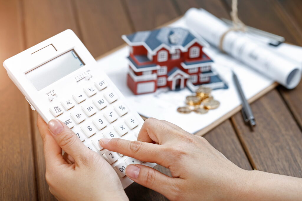 Woman using a calculator for a home mortgage
